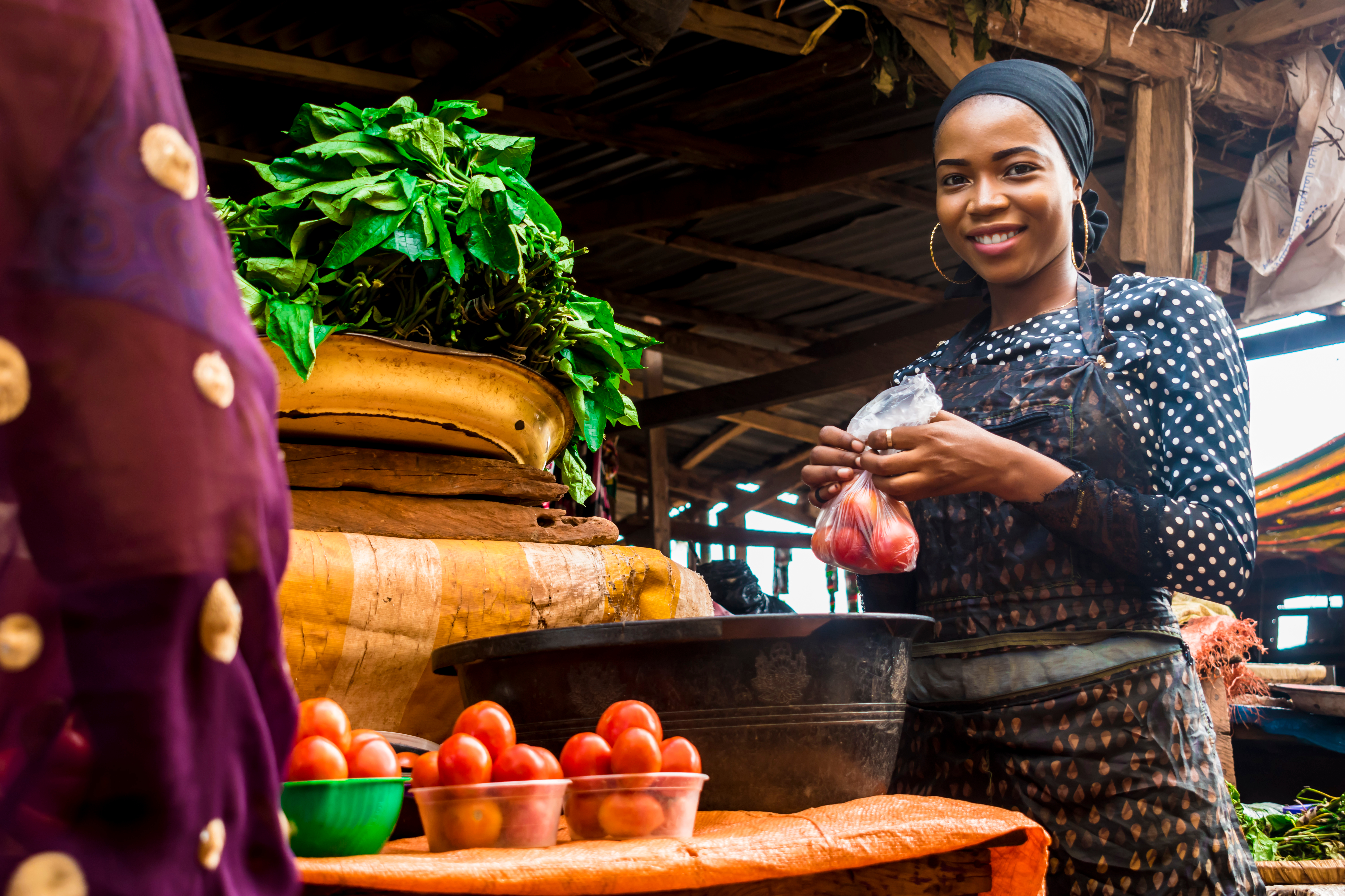 image of african woman with their product for sale.