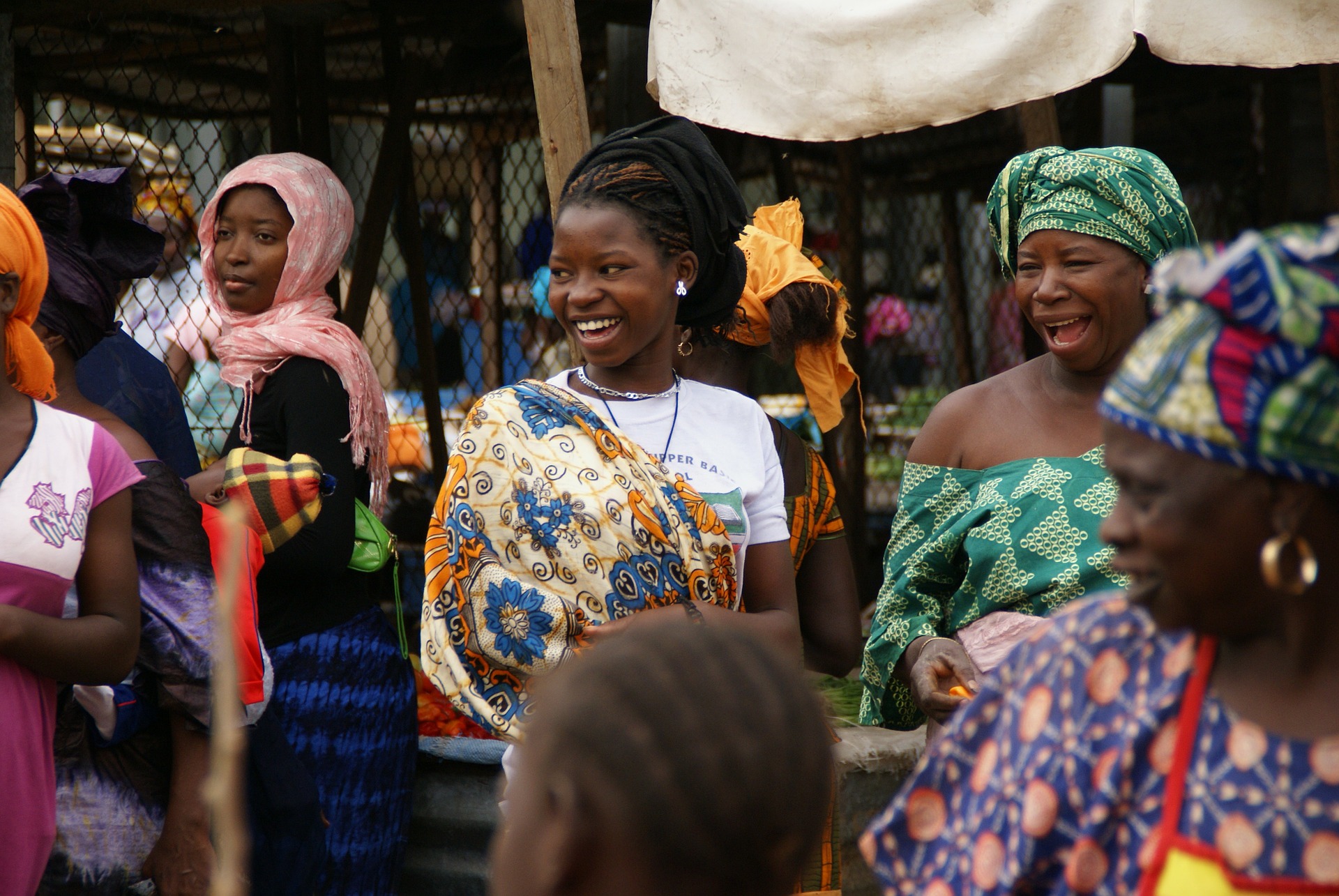 African women in a group smiling and looking happy.